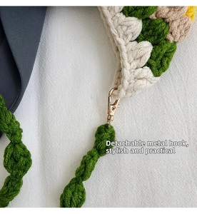 Detail of crochet sunflower bag with removable golden metal hook and woven green strap