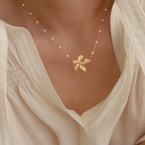 18K gold plated titanium necklace with white beads and flower petal charms for women