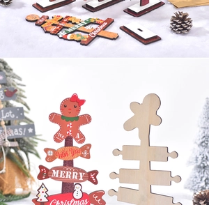 Detail of wooden Merry Christmas table signs with gingerbread man on a snowy base