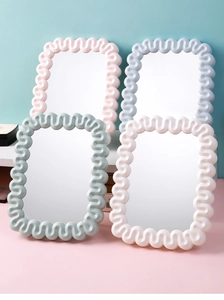 Collage of four wavy-edged makeup mirrors in pastel pink, blue, green, and cream colors