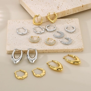 Detailed close-up of U-shaped stainless steel earrings in gold and silver finish