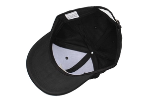 Interior detail of black baseball cap showing 100% polyester fabric and metal buckle