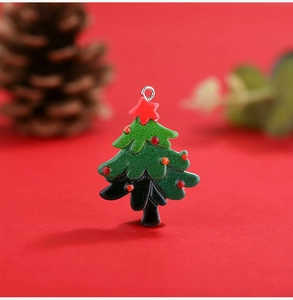 Detail of a Christmas tree resin pendant with red star and ornaments on red background