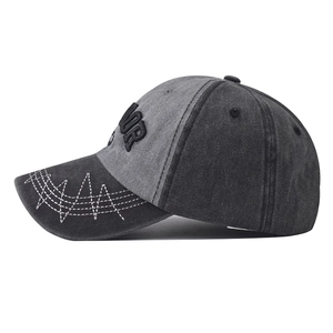Detail of vintage washed canvas baseball cap with white contrast stitching and embroidery