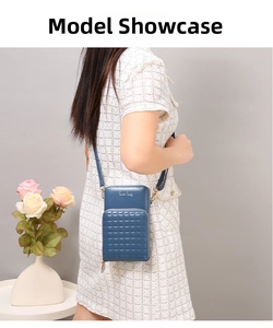 Deep blue crossbody phone bag with square embossed pattern shown on a model