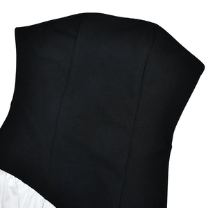 Detail shot of black backless bodice stitching with contrasting white flowing fabric