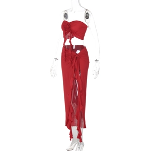 Detail of red two-piece set featuring rose tube top and high-slit ruffled maxi skirt