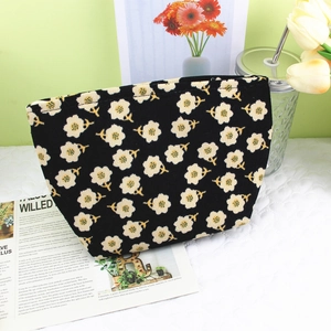 Vintage black corduroy floral makeup bag with white flower prints and zipper closure