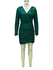 Detail of green sequin dress showing deep V-neckline and textured ruching fabric