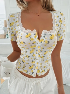 Close-up of Y2K floral short sleeve top with lace square neck and button front details