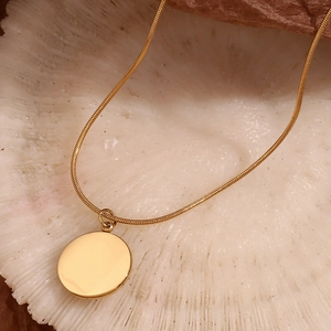 18K gold plated snake chain necklace with hammered round coin pendant on coral stone