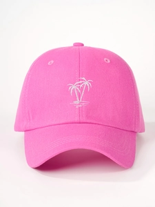 Detailed view of white palm tree embroidery on a rose pink cotton baseball cap