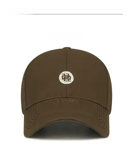 Detail of embroidered logo and DHANY embossed text on a dark brown cotton baseball cap