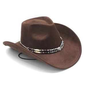 Detail of dark brown cowboy hat featuring ethnic beaded band and metallic buckle