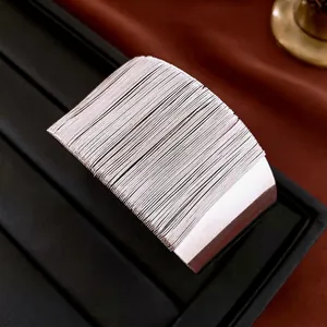 Minimalist silver multi-layer wire open cuff bracelet displayed on a black jewelry stand