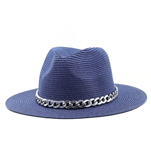 Detail of navy straw fedora hat featuring a decorative silver metal chain band