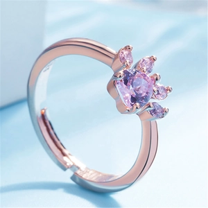 Detailed macro view of a rose gold pet paw ring with heart-shaped purple zircon stone