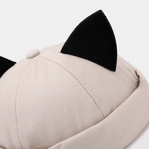 Beige cotton docker cap featuring cute black cat ears detail and stylish twill fabric