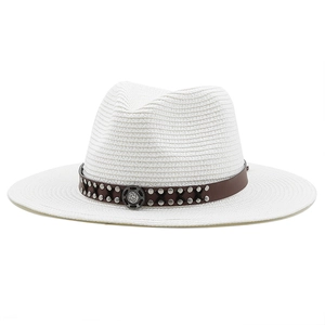 Macro shot of white woven fedora hat with brown leather band and metallic rivet details