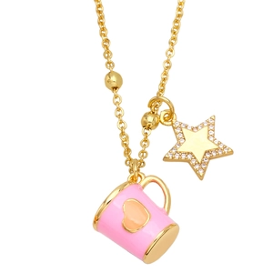 Macro detail of gold necklace with pink enamel heart cup and sparkling star pendants