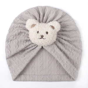 Gray knitted baby turban hat with a cute white plush bear patch for spring comfort