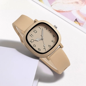 Detail of square beige watch dial with Arabic numerals and silicone strap on soft background