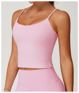 Detailed view of the pink U-neck yoga sports vest with thin shoulder straps on a model