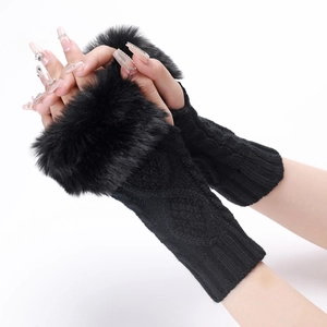 Close-up of black knit arm warmers with cable pattern and plush faux fur cuffs