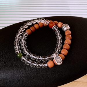 Detail of S925 silver beaded bracelet with white crystal and sandalwood beads