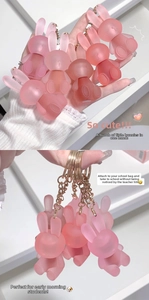 Close-up of cute pink bunny keychains with matte finish and golden metal rings