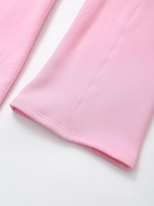 Detail shot of the pink knit trousers leg opening with high-quality stitching and fabric texture