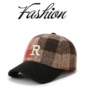 Detail of plaid winter baseball cap with white 3D R-letter embroidery and black wool brim