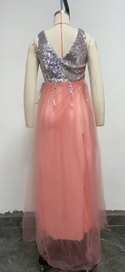 Detail of pink and silver sequin evening dress featuring a deep V-back and mesh skirt