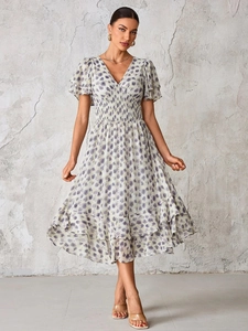 Bohemian V-neck floral maxi dress with layered ruffle sleeves and a tiered skirt design