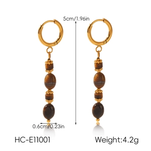 Detailed macro view of gold-plated tiger eye tassel earrings with dimensions and weight info