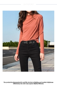 Detail of classic black leather belt with an oval metal buckle on outdoor model