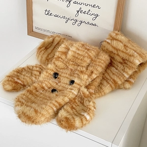 Detailed view of plush orange tiger-striped material with cute animal face elements