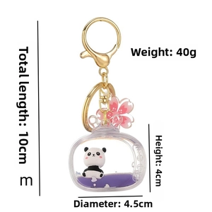 Detailed size view of panda liquid keychain in purple oil with cherry blossom charm
