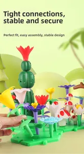 Close-up of DIY building block garden with colorful flowers and cactus on grass base