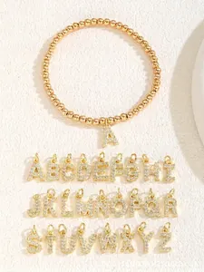 Detail view of 26 gold beaded alphabet charms with sparkling zircon stone inlay