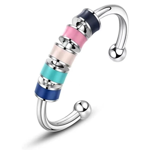 Silver stainless steel spinner ring with five colorful enamel beads on a white background