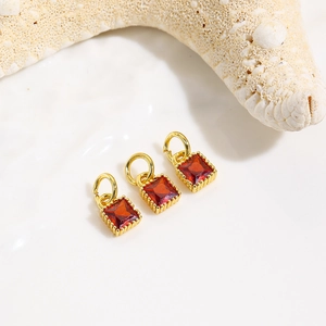 Detail of square red zircon pendant charms in 18k gold plating for jewelry making