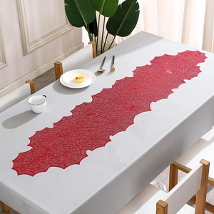 Close-up of red lace spider web table runner with high-quality gold stamping details