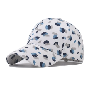 White cotton baseball cap with blue abstract graffiti pattern and curved visor brim