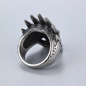 Detailed view of the polished inner band and punk style silver spikes on the crown ring