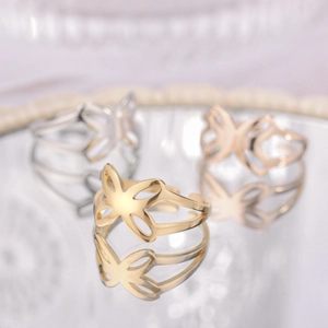 Close-up of elegant hollow butterfly rings in gold, silver and rose gold finish