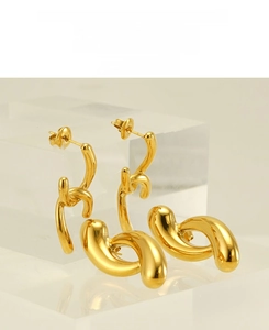 Detailed macro view of 18k gold plated stainless steel earrings on acrylic blocks