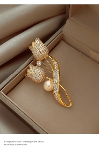 Detailed close-up of a luxury tulip brooch with pearls and pavé diamonds on silk