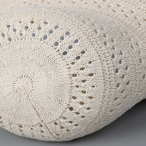 Macro detail of breathable hollow knit pattern on this beige summer bucket hat