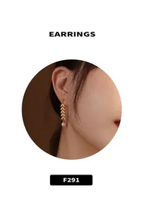 Elegant gold leaf chain drop earrings with a round white pearl on a female model